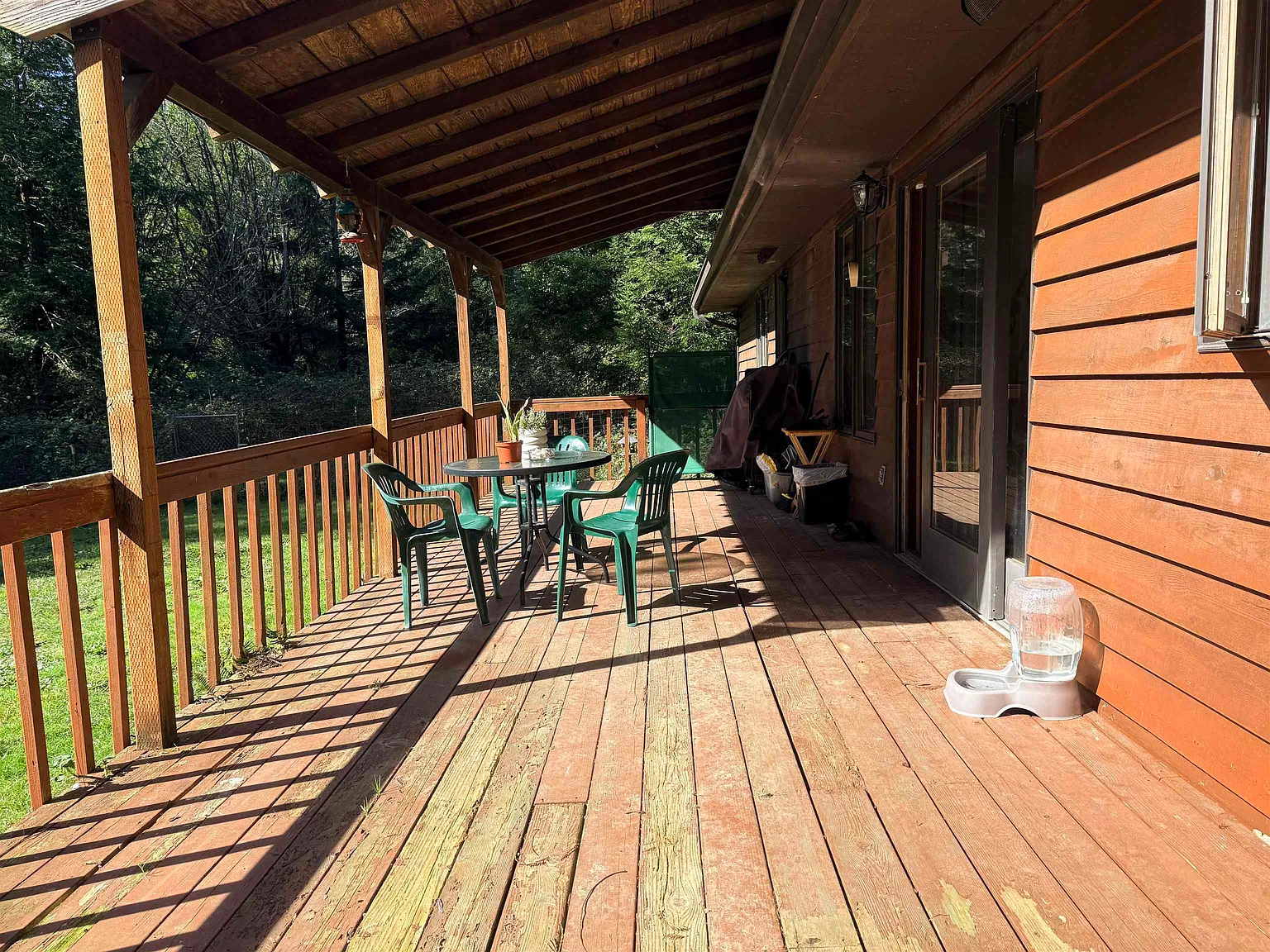 The covered back deck, set up with an outdoor dining table.